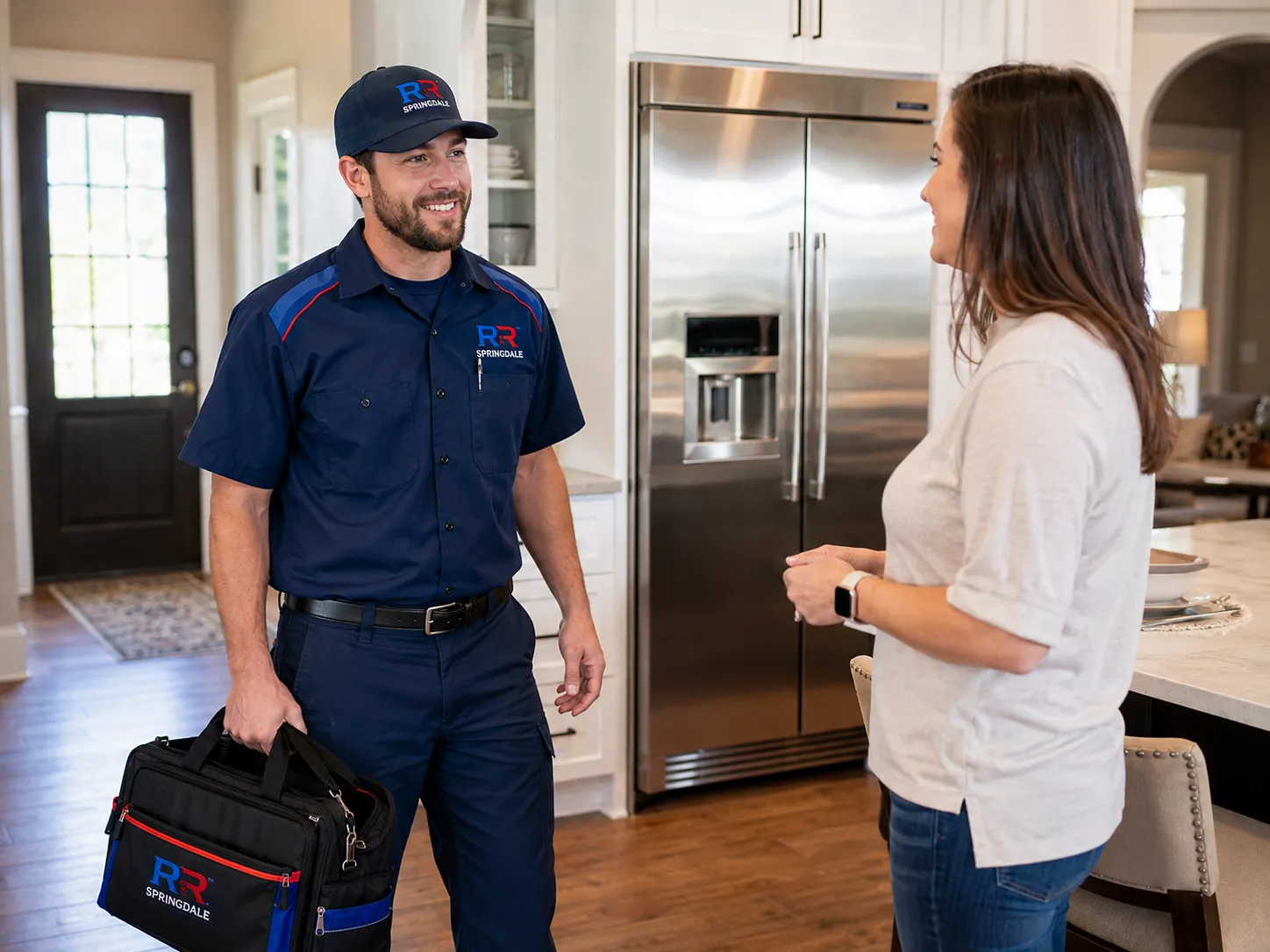 RR Springdale technician speaking with a homeowner before ice maker repair in Springdale, AR.